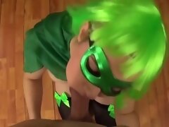 Babe With Green Hair And A Matching Mask Is Kneeling On The Floor And Sucking Dick